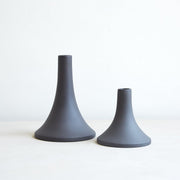 The Floral Society | Candle Holders, Grand, Matte White Tall: Two ceramic candlestick holders, one tall and slender, the other short with a wide base, perfect for standard taper candles.