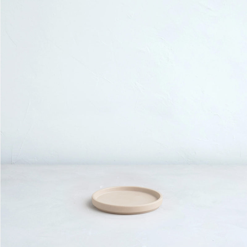The Floral Society | Daily Plate, Sand: A round, shallow ceramic dish, ideal for candles or as a versatile catchall, resting on a white surface.