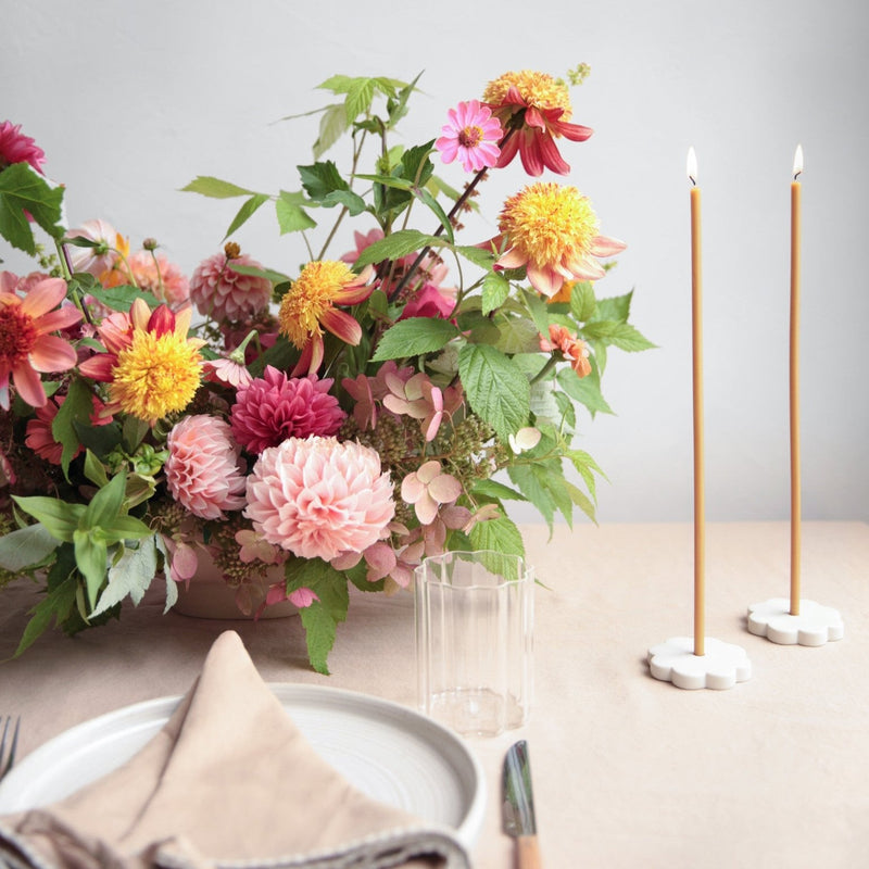 The Floral Society | Long Stem Beeswax Candles in white holders, creating an elegant, cozy tabletop scene with vibrant garden blooms, embodying Athens Cooks' curated kitchen artistry.