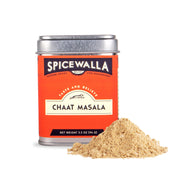 Spicewalla | Chaat Masala tin with a small pile of tangy, salty spice blend, featuring amchoor, black salt, cumin, and more, ideal for Indian cuisine.
