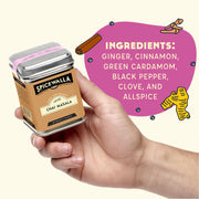 Spicewalla Chai Masala tin held in hand, featuring ingredients and brewing instructions for crafting Indian street-inspired chai, perfect for beverages, desserts, and baking.