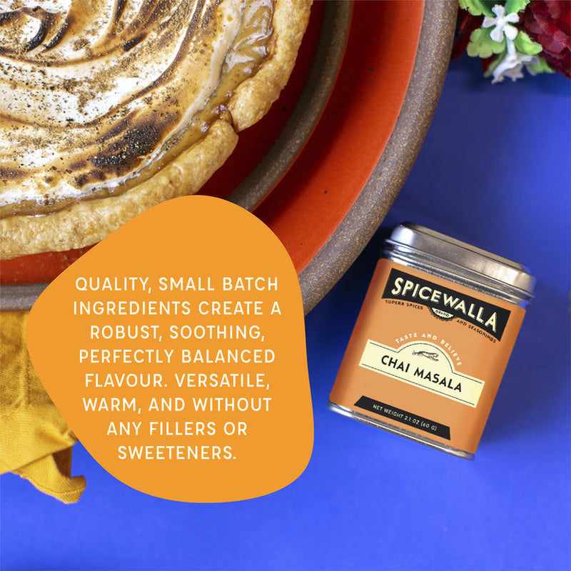 Spicewalla | Chai Masala tin beside a browned meringue tart on an orange-rimmed plate, with a call-out highlighting its robust, versatile, filler-free flavor.