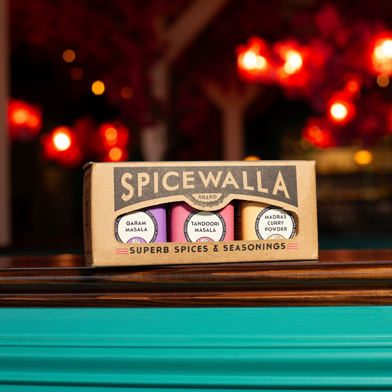 Spicewalla | Chai Pani Restaurant Collection, 3-Pack Gift Set featuring Garam Masala, Tandoori Masala, and Madras Curry Powder jars on a wooden countertop.