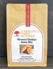 Carolyn's Farm Kitchen Vermont Cheddar Scone Mix in a kraft-paper pouch, featuring a label with scone image and ingredient details for making savory scones.