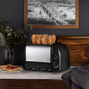 Dualit | 4 Slice Classic Toaster, Matt Black, with golden-brown toast, showcased in a stylish kitchen setting, emphasizing quality craftsmanship and functionality.