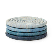 St. Frank | Ombré Coaster Collection - Blue: a stack of handcrafted woven coasters, showcasing traditional basket weaving techniques, tied with a black grosgrain ribbon for elegant presentation.