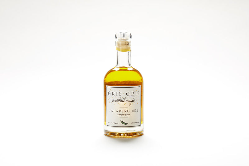 Gris Gris | Cocktail Magic Simple Syrup - Jalapeño Hex bottle, a premium mixer blending jalapeño flavors for cocktails, showcased in a sleek glass bottle with a white label.