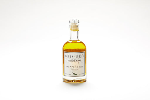 Gris Gris | Cocktail Magic Simple Syrup - Jalapeño Hex bottle, a premium mixer blending jalapeño flavors for cocktails, showcased in a sleek glass bottle with a white label.