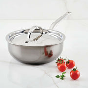 Hestan NanoBond | Cookware - 5qt Essential Pan + Lid on marble countertop, accompanied by vine-ripened cherry tomatoes and fresh herb, showcasing premium, durable stainless-steel design.