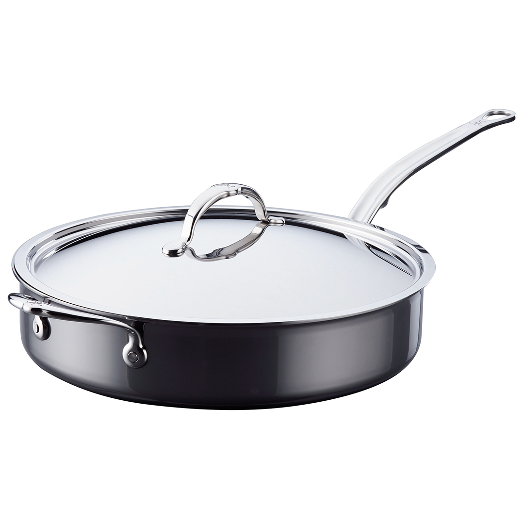 Hestan NanoBond | Cookware - 5qt Essential Pan + Lid features a metal sauté pan with long and helper handles, topped by a stainless-steel lid.