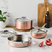 Hestan Provisions | Stainless Steel Lids Large, 12.5 showcased with copper cookware on a marble countertop, emphasizing durability and ergonomic design for optimal kitchen performance.