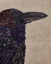 Coral & Tusk | Blackbird with Acorn Pillow features vibrant embroidered feathers and an acorn, symbolizing new beginnings. Perfect for adding artistic flair to your kitchen decor.