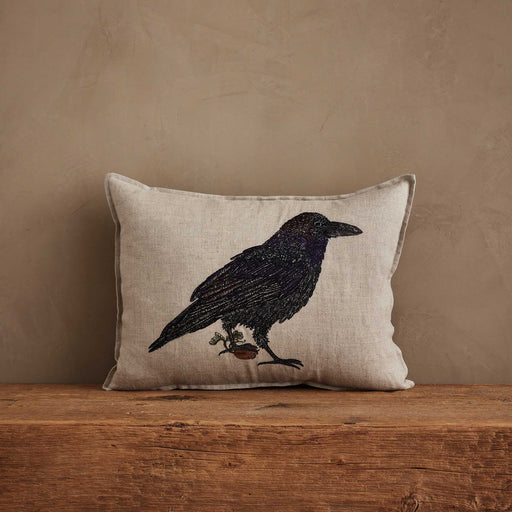 Coral & Tusk | Blackbird with Acorn Pillow: Linen pillow with embroidered crow, acorn, and sprig, embodying rustic charm and new beginnings.