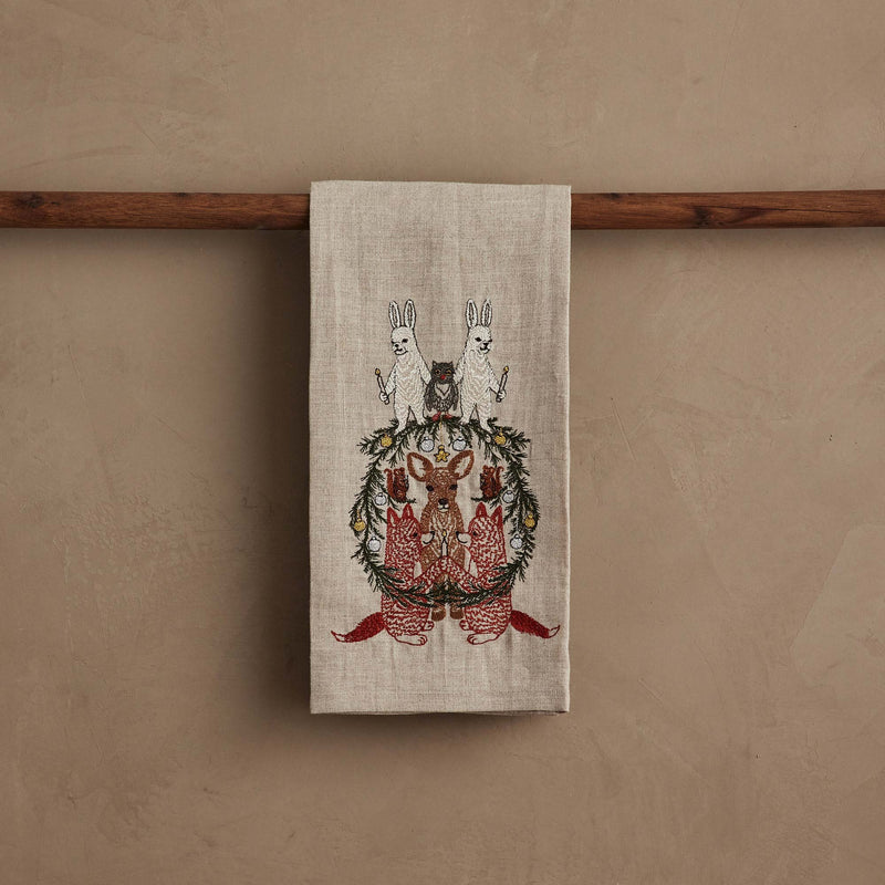 Coral & Tusk | Togetherness Tea Towel featuring embroidered woodland animals and a pine-needle wreath, perfect for adding a festive touch to your kitchen.