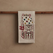 Coral & Tusk | Cookie Workshop Tea Towel, showcasing a gingerbread house scene with festive embroidery, ideal for adding holiday charm to your kitchen or powder room.