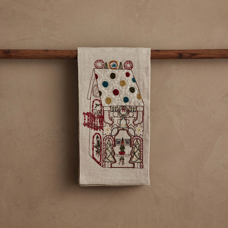 Coral & Tusk | Cookie Workshop Tea Towel, showcasing a gingerbread house scene with festive embroidery, ideal for adding holiday charm to your kitchen or powder room.