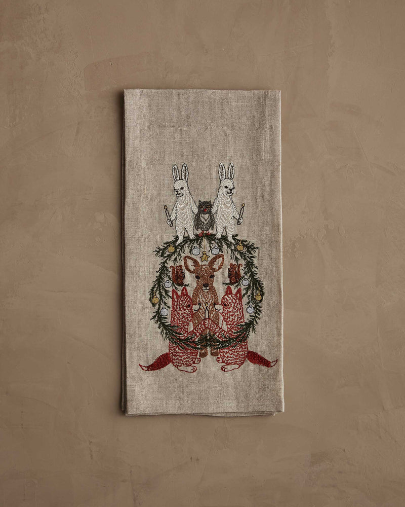 Coral & Tusk | Togetherness Tea Towel with embroidered woodland animals and a wreath, ideal for festive cabin or holiday decor from Athens Cooks.