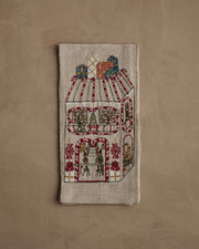 Coral & Tusk | Toy Workshop Tea Towel featuring embroidered whimsical gingerbread house scene with elves, candy accents, and gifts, perfect for a festive kitchen decor.