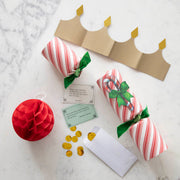 Hester & Cook Christmas Crackers - Candy Cane, designed for festive dining, include a honeycomb ball, confetti, gold crown, and conversation card. Perfect for holiday celebrations.