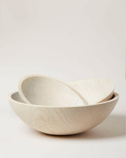 Farmhouse Pottery's 17 crafted wooden bowls, designed for serving salads or as decor, embody a farm-to-table ethos with convenient nested storage.