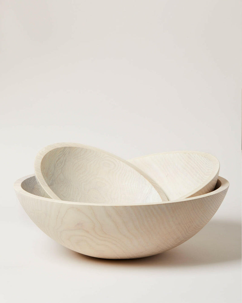 Farmhouse Pottery's 17 crafted wooden bowls, designed for serving salads or as decor, embody a farm-to-table ethos with convenient nested storage.