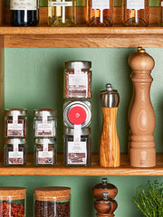 Peugeot | Paris Classic Salt Mill, Natural Wood, 9 inches, showcased among spices and jars on a kitchen shelf, embodying Athens Cooks' curated kitchen essentials.