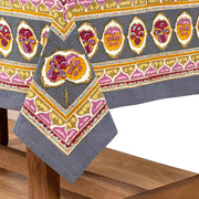 Caravan Home | 71 x 71 Pansy Red & Grey Tablecloth features vibrant floral and abstract patterns, handprinted on French linen, embodying unique craftsmanship.