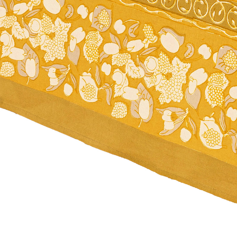 Forest Harvest Grey & Mustard Tablecloth features a hand-printed fruit and foliage design, showcasing Provençal inspiration with artisan craftsmanship, ideal for enhancing dining experiences.