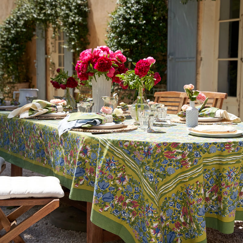 Caravan Home | 59 x 86 Jardin Blue & Vert Tablecloth elegantly set on a dinner table with floral design, featuring a vase centerpiece, enhancing indoor or outdoor dining.