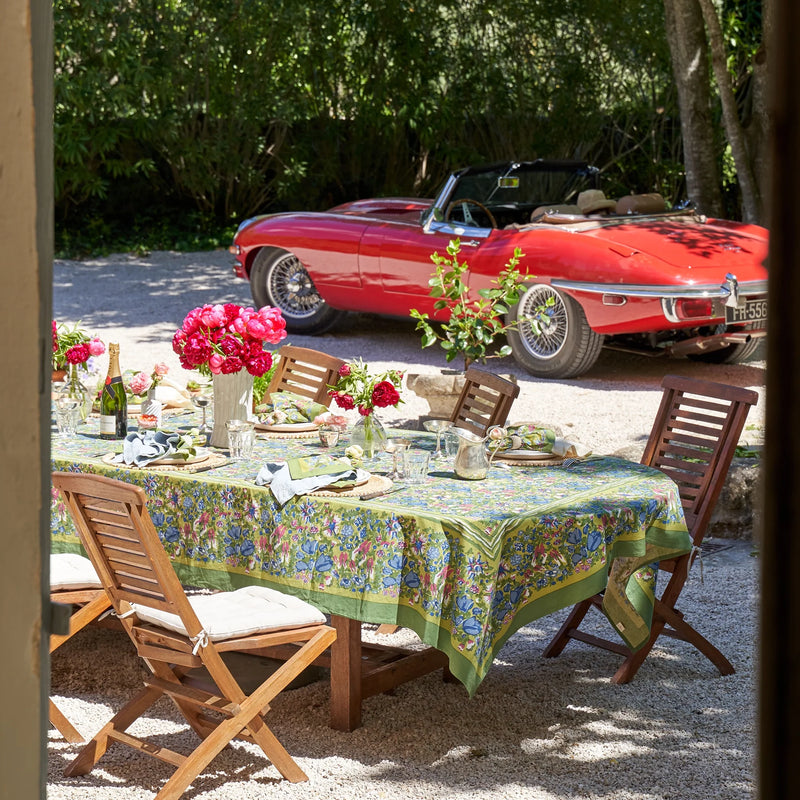 Caravan Home | 59 x 86 Jardin Blue & Vert Tablecloth, handprinted, on an outdoor table set for dining, embodying Southern France garden elegance.