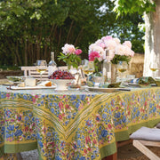 Caravan Home | 59 x 86 Jardin Blue & Vert Tablecloth on an outdoor table with food, wine, and flowers, showcasing artisan craftsmanship inspired by Southern France gardens.