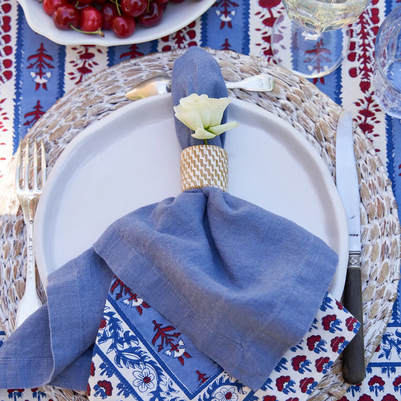 Caravan Home | 21 x 21 Lake Everyday Napkins Set of 4, showcasing refined linen with mitered corners, elegantly set with cherries and tableware.