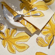 Caravan Home 19 x 19 Fig Citrine Napkins Set of 6 displayed with a spoon, highlighting the handprinted design ideal for elevating dining experiences.