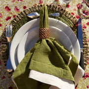 Caravan Home 21x21 Avocado Everyday Napkin Set of 4 on a plate with silverware, showcasing refined, casual luxury and exquisite craftsmanship.