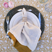 Caravan Home | 21 x 21 Ivory Everyday Napkins Set of 4 elegantly displayed on a plate with a fork, showcasing their soft linen texture and mitered corners.