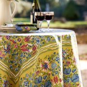 Caravan Home | 71 x 71 Jardin Blue & Vert Tablecloth on a set dining table adorned with wine glasses, showcasing handprinted floral motifs inspired by Southern France gardens.