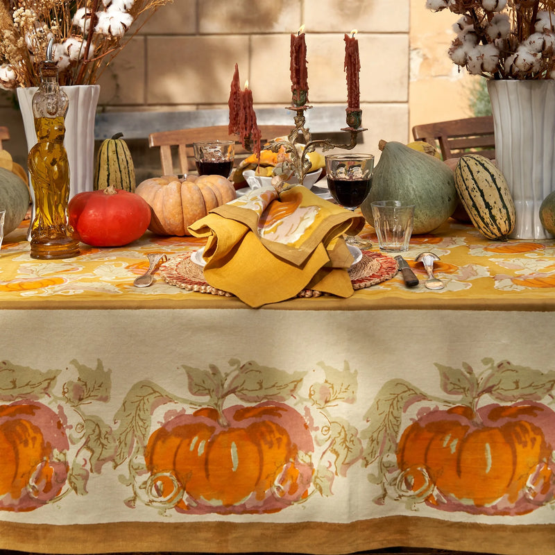 Caravan Home | 21 x 21 Dijon Everyday Napkins Set of 4 on a decorated table with pumpkins and candles, showcasing elegance and craftsmanship.