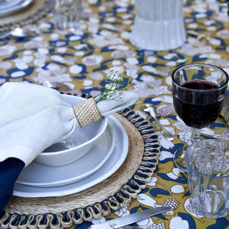 Caravan Home | 21 x 21 White Everyday Napkins Set of 4 displayed on an elegantly set dining table with plates, glasses, and silverware.