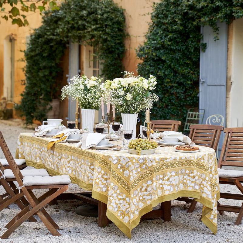 Caravan Home | 21 x 21 Stone Everyday Napkins Set of 4 elegantly displayed on a table set for a dinner party, featuring a bowl of grapes and floral centerpieces.