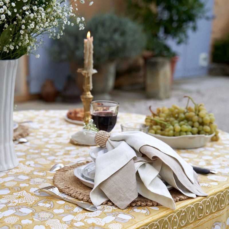 Caravan Home | 21 x 21 Stone Everyday Napkins Set of 4 elegantly arranged on a table with grapes, enhancing a sophisticated dining experience.