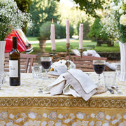 Caravan Home | 71 x 106 Forest Harvest Grey & Mustard Tablecloth on outdoor table with wine, candles, and floral centerpieces, highlighting its hand-printed craftsmanship.