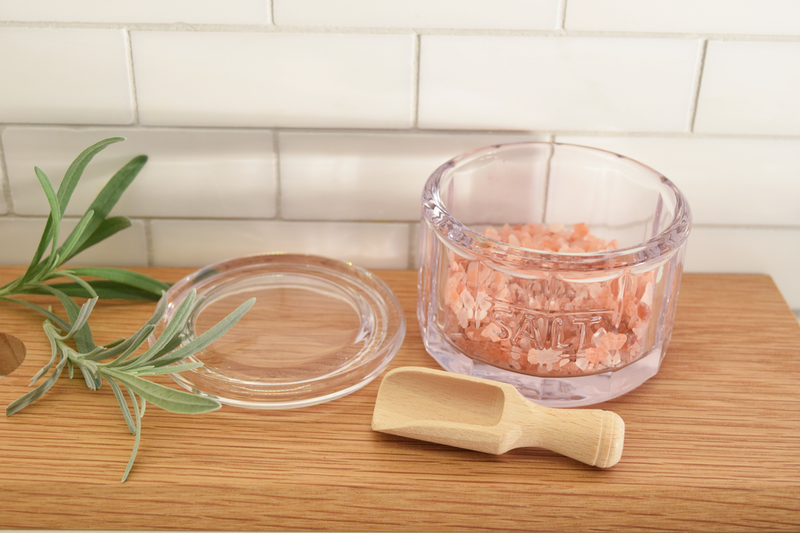 Earth & Nest Salt Pot + Scoop set, featuring a glass container with pink salt and a wooden spoon, designed to enhance your kitchen's elegance and functionality.