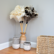 Earth & Nest | Feather Duster, featuring premium feathers in a vase, with a blond wood handle and leather ferrule, perfect for elegant cleaning solutions.