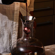 Holcomb Studio | Birdie Wine Decanter being filled with red wine, showcasing its hand-blown glass design and aerating sphere for enhanced aroma and flavor.