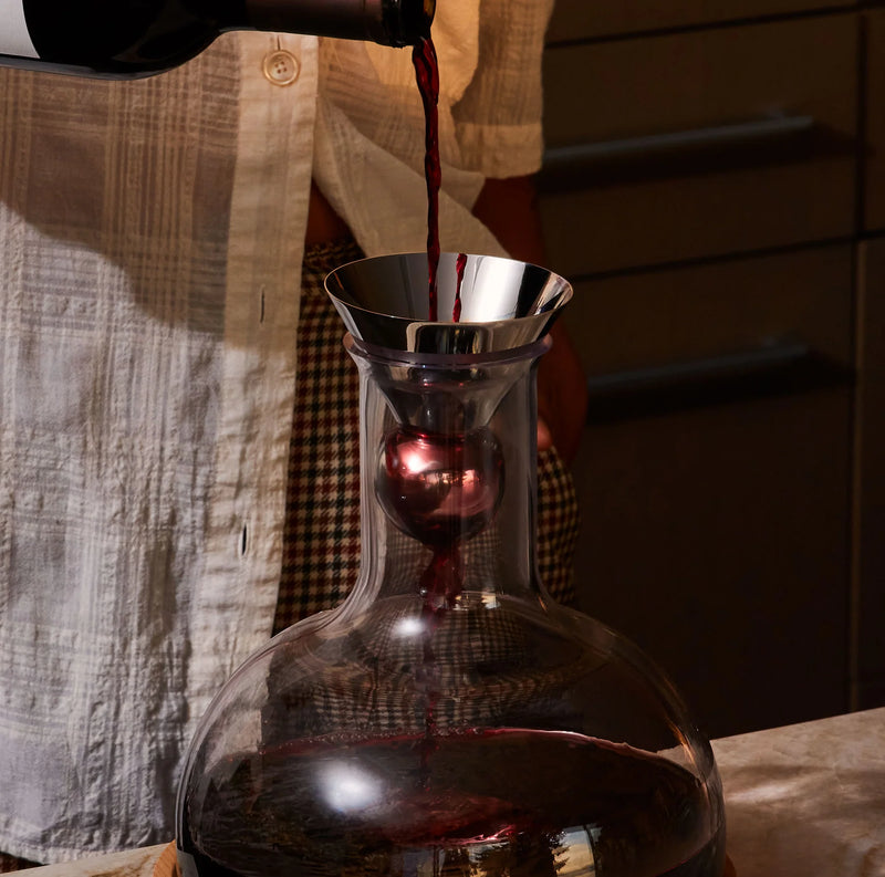 Holcomb Studio | Birdie Wine Decanter being filled with red wine, showcasing its hand-blown glass design and aerating sphere for enhanced aroma and flavor.
