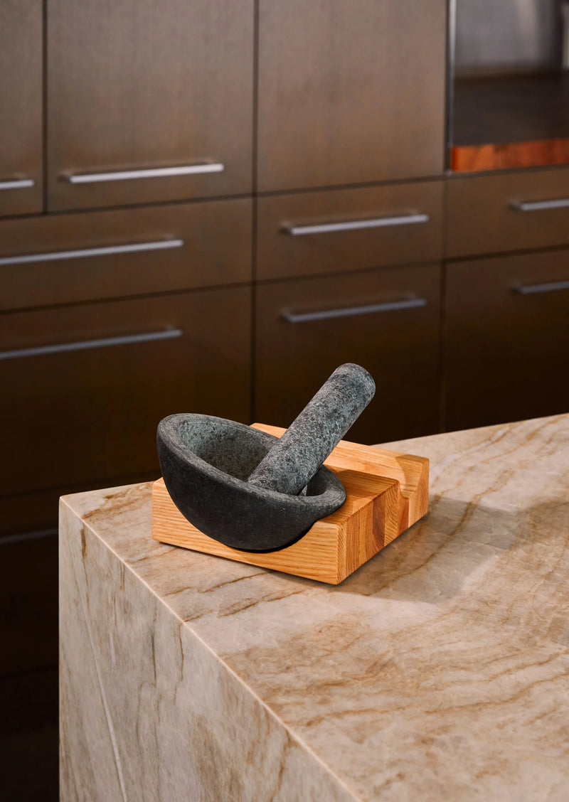 Holcomb Studio | Perch Mortar & Pestle on a wooden base, ideal for grinding spices and making pestos, on a kitchen countertop.