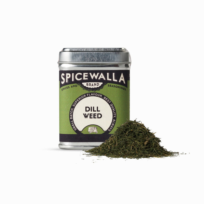 Spicewalla | Dill Weed seasoning tin with dried dill spilled in front, showcasing its refreshing, grassy flavor, ideal for enhancing preserved dishes.