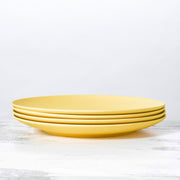 Stack of yellow bamboo plates from Fable New York's eco-friendly dinnerware collection, available at Athens Cooks, ideal for sustainable dining.