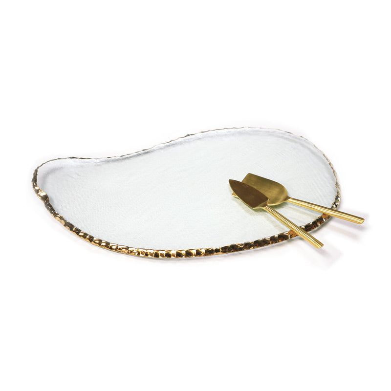 Annie Glass | Edgey Cheese Board: Irregular clear glass platter with 24k gold rim, paired with matching gold-tone utensils. Perfect for elegant serving.