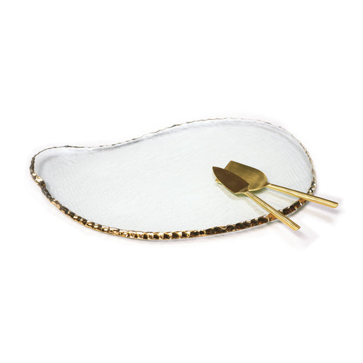 Annie Glass | Edgey Cheese Board: Irregular clear glass platter with 24k gold rim, paired with matching gold-tone utensils. Perfect for elegant serving.